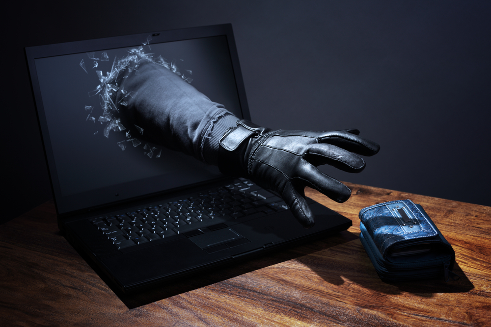 A conceptual image depicting a purse being stolen through a laptop, symbolizing computer hacking, network security risks, and electronic banking vulnerabilities.